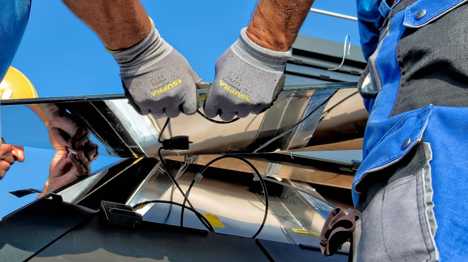 Technician wiring a solar junction box